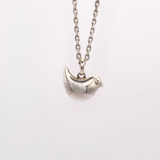 Silver bird-shaped pendant on a chain against a white background