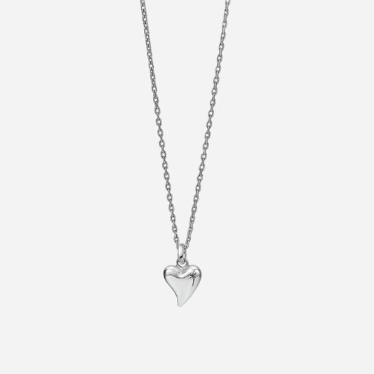 Silver heart-shaped pendant on a chain against a white background