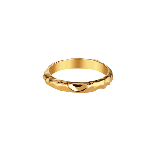 A gold band ring with a textured finish and a special indentation designed to fit with an engagement ring.