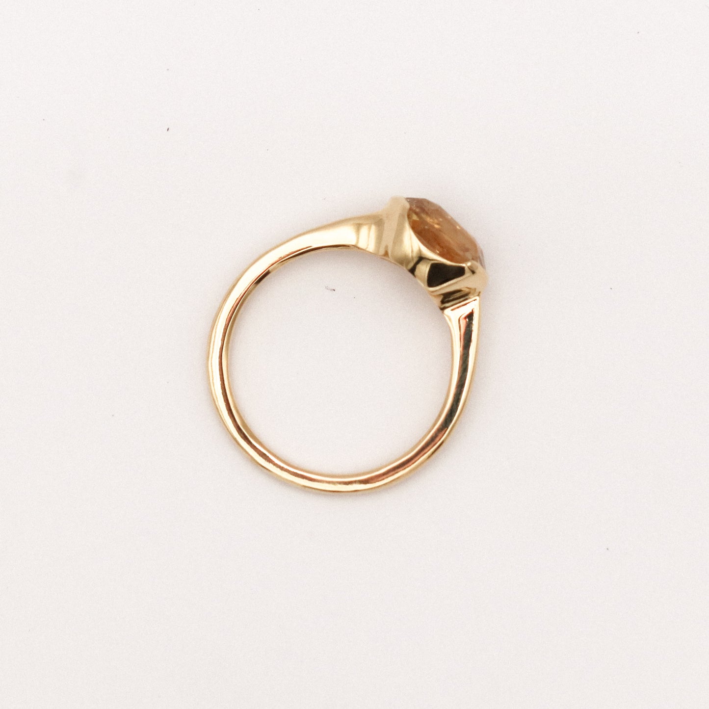 Gold ring with a stone on a white background