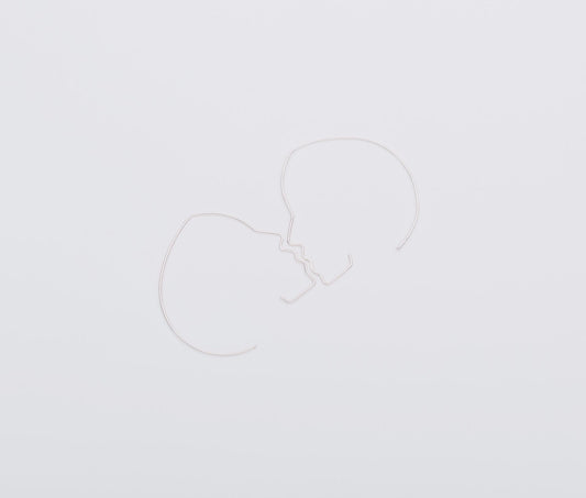 Two white heart-shaped balloons on a light gray background