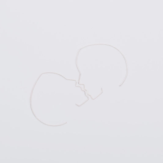 Two white heart-shaped balloons on a light gray background