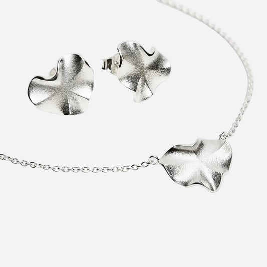 Silver stingray necklace and earrings on a white background