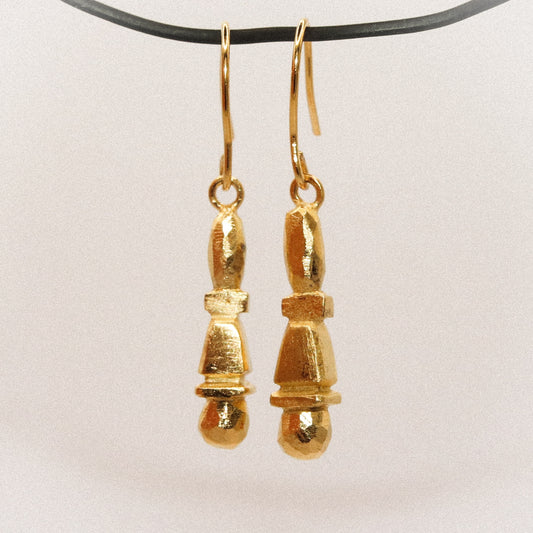 Gold earrings on a white background