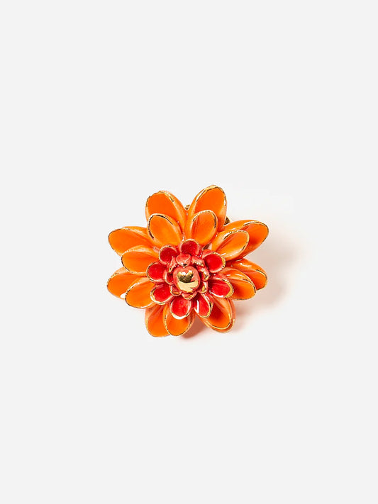 Orange flower-shaped object on a white background