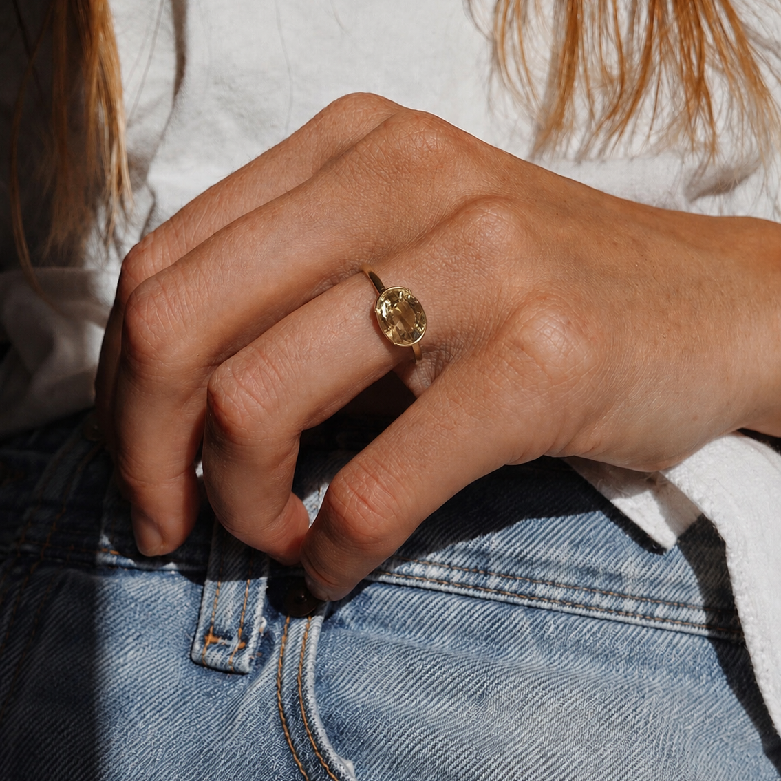 Close-up of a hand wearing a ring on a blurred background