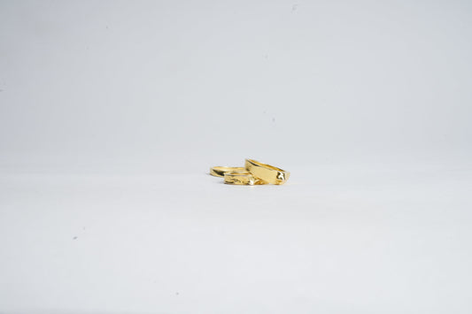 Gold ring with a unique design on a white background