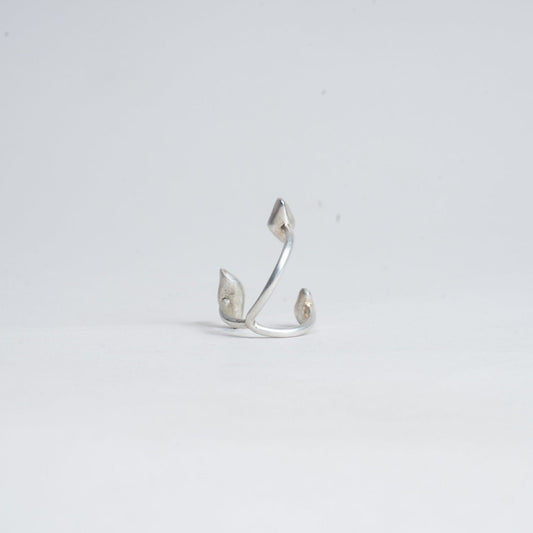 Silver earring on a light gray background