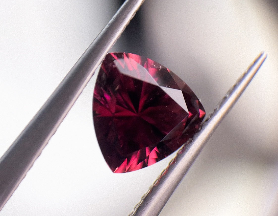 Heart-shaped rubellite from Malhan held in tweezers