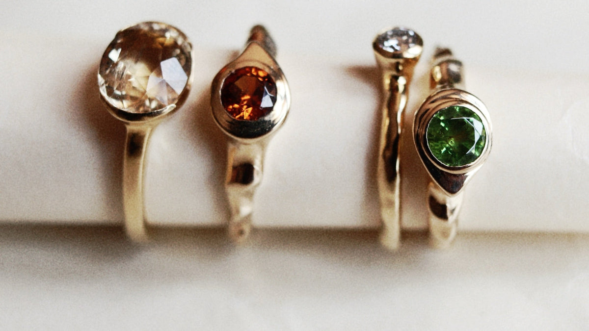 Gemstone rings showing different stone setting styles at Dune Workshop