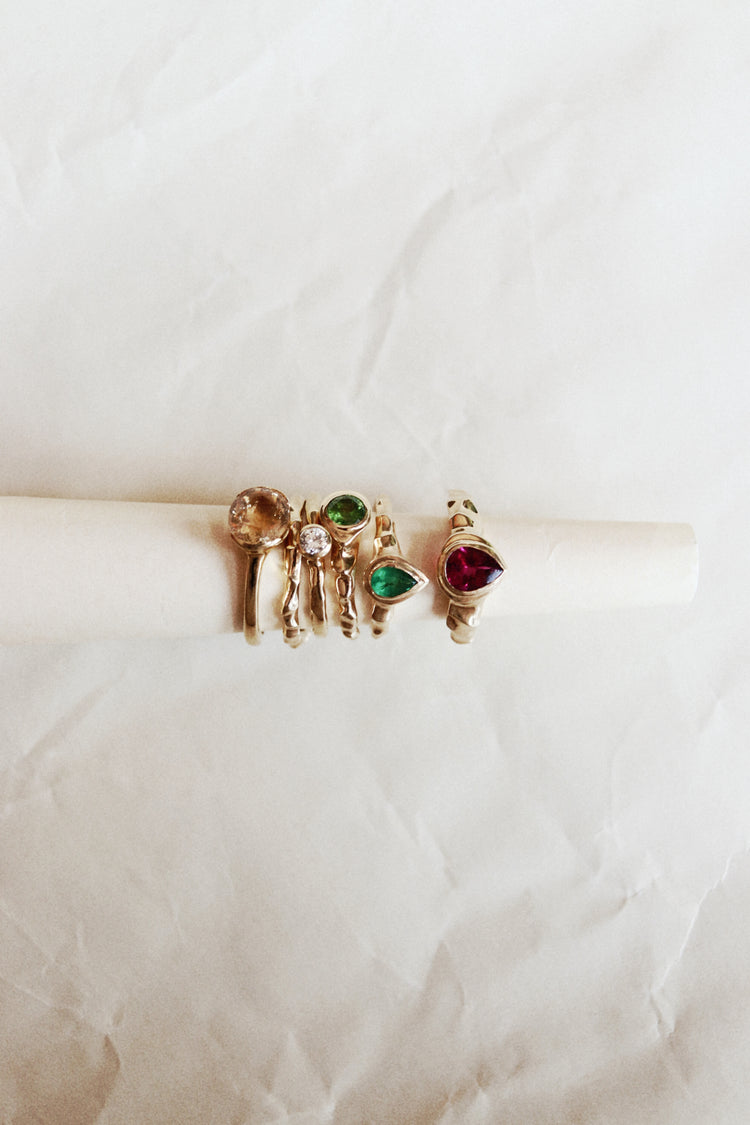 Dune Workshop rings with natural gemstones on a pale jewellery display