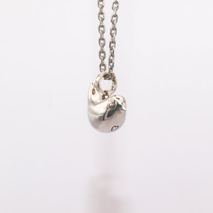 Silver necklace with a heart-shaped pendant on a white background