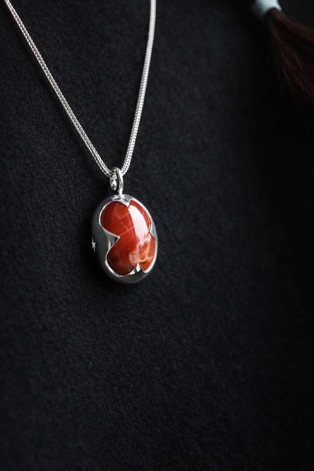 Necklace with a red pendant on a dark background