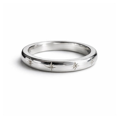 Silver ring with star designs on a white background