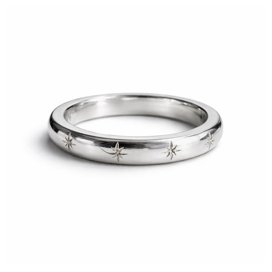 Silver ring with star designs on a white background