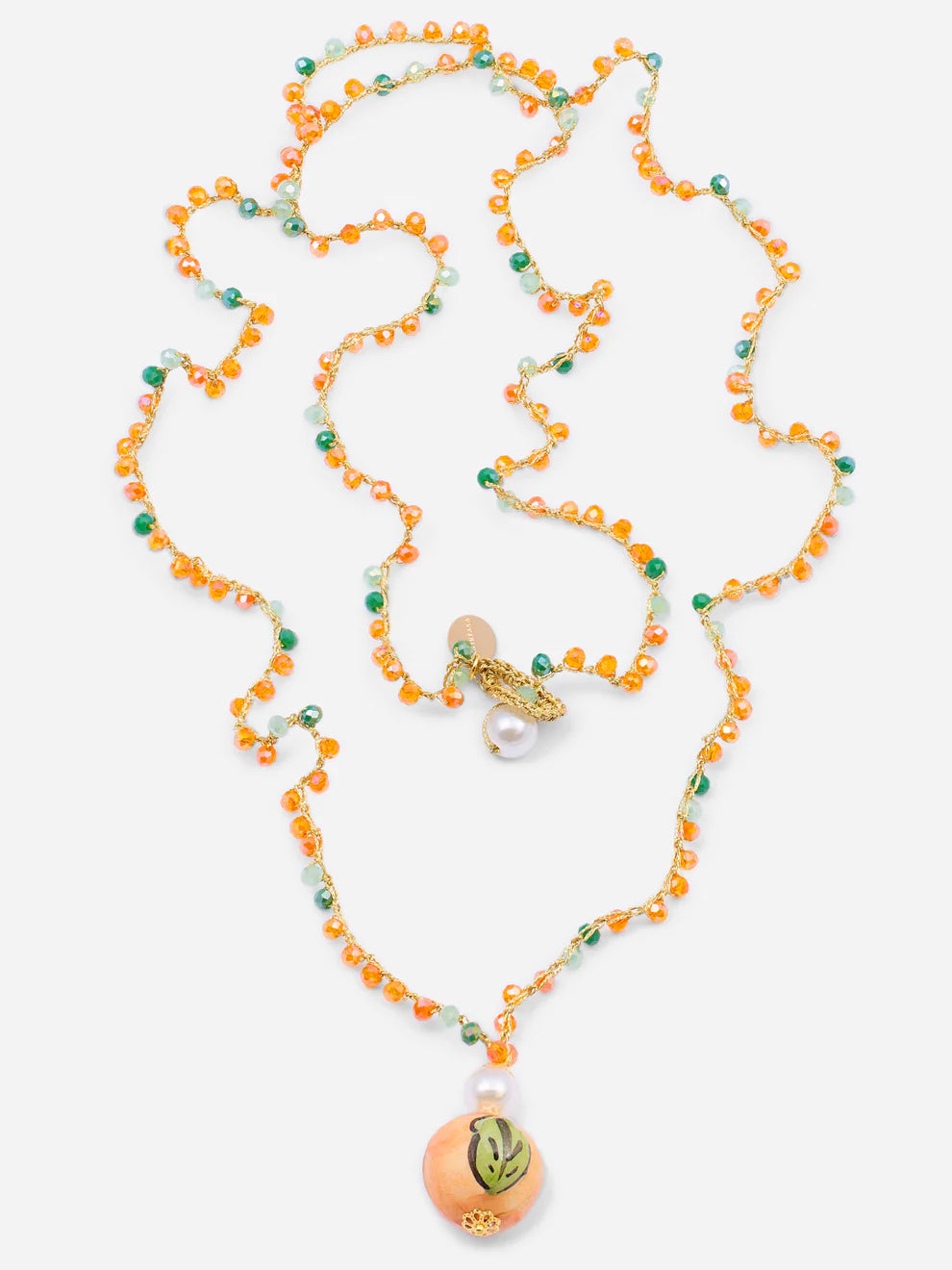 Necklace with orange and green beads on a white background