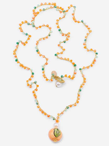 Necklace with orange and green beads on a white background