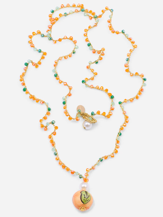 Necklace with orange and green beads on a white background