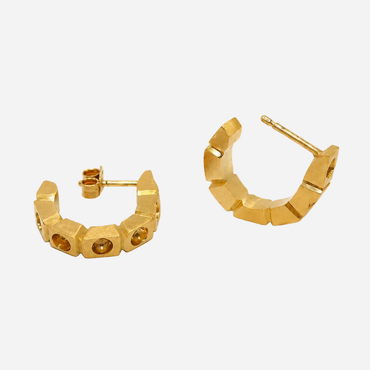 Gold hoop earrings on a transparent background