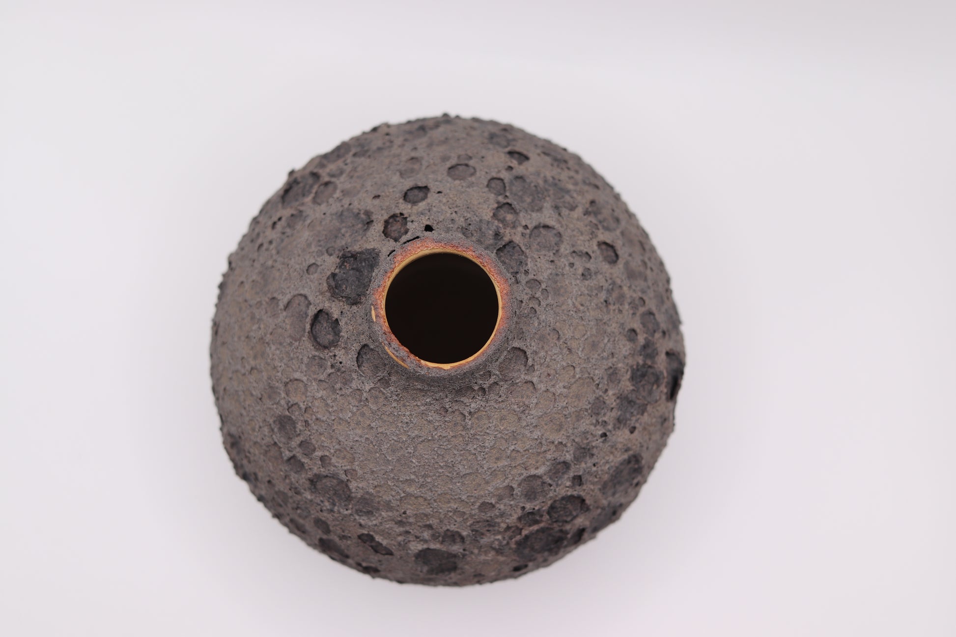Black textured ceramic vase on a white background