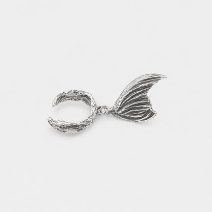 Silver mermaid tail charm on a white background