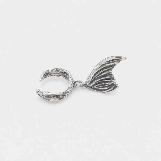 Silver mermaid tail charm on a white background