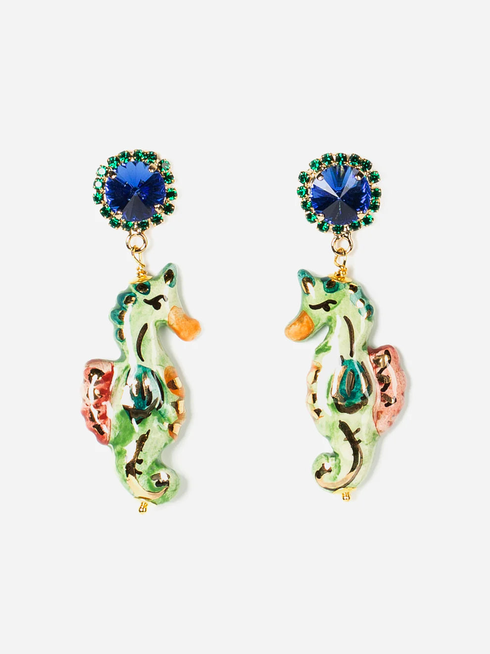 Colorful seahorse-shaped earrings with blue gemstones on a white background