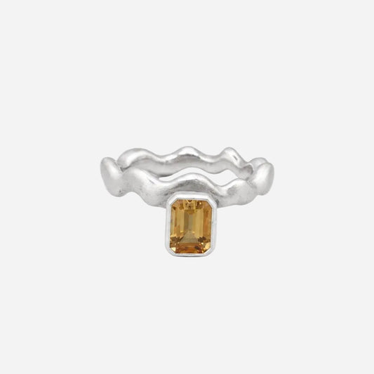 Silver ring with a rectangular gemstone on a white background