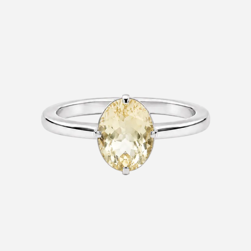 A silver ring featuring a marquise-cut pale yellow gemstone in a prong setting, shown against a plain white background.
