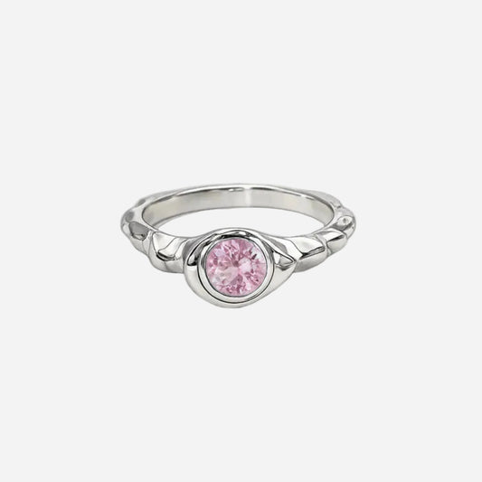 Silver ring with a pink gemstone on a white background