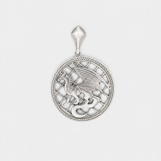 Silver pendant with intricate design on a light gray background