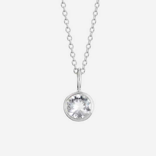 A silver chain necklace with a round bezel-set clear gemstone pendant, shown against a plain white background.