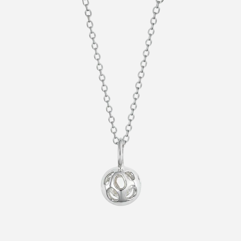 A silver necklace with a delicate chain and a circular pendant featuring cutout details, shown against a plain white background.