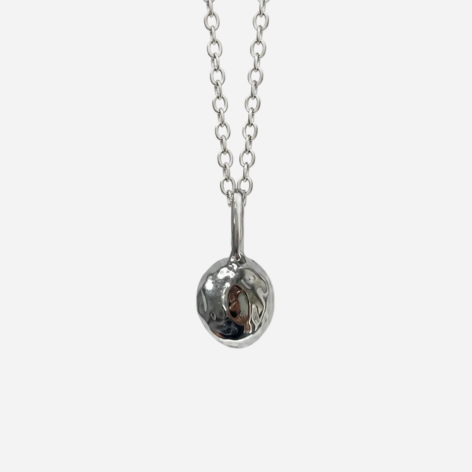 A silver chain necklace with a polished, spherical pendant, shown against a plain white background.