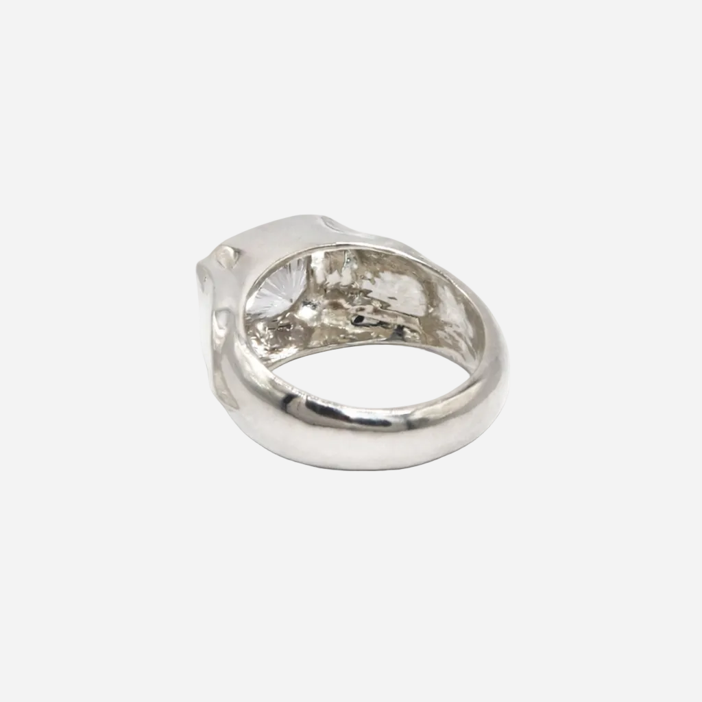 Silver ring with a large diamond on a white background