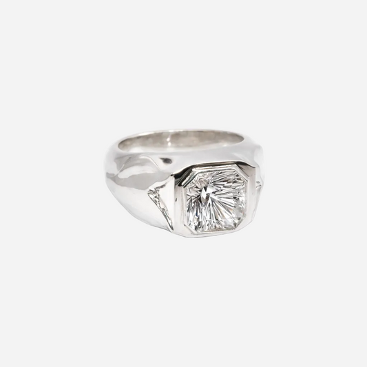 Silver ring with a large diamond on a white background