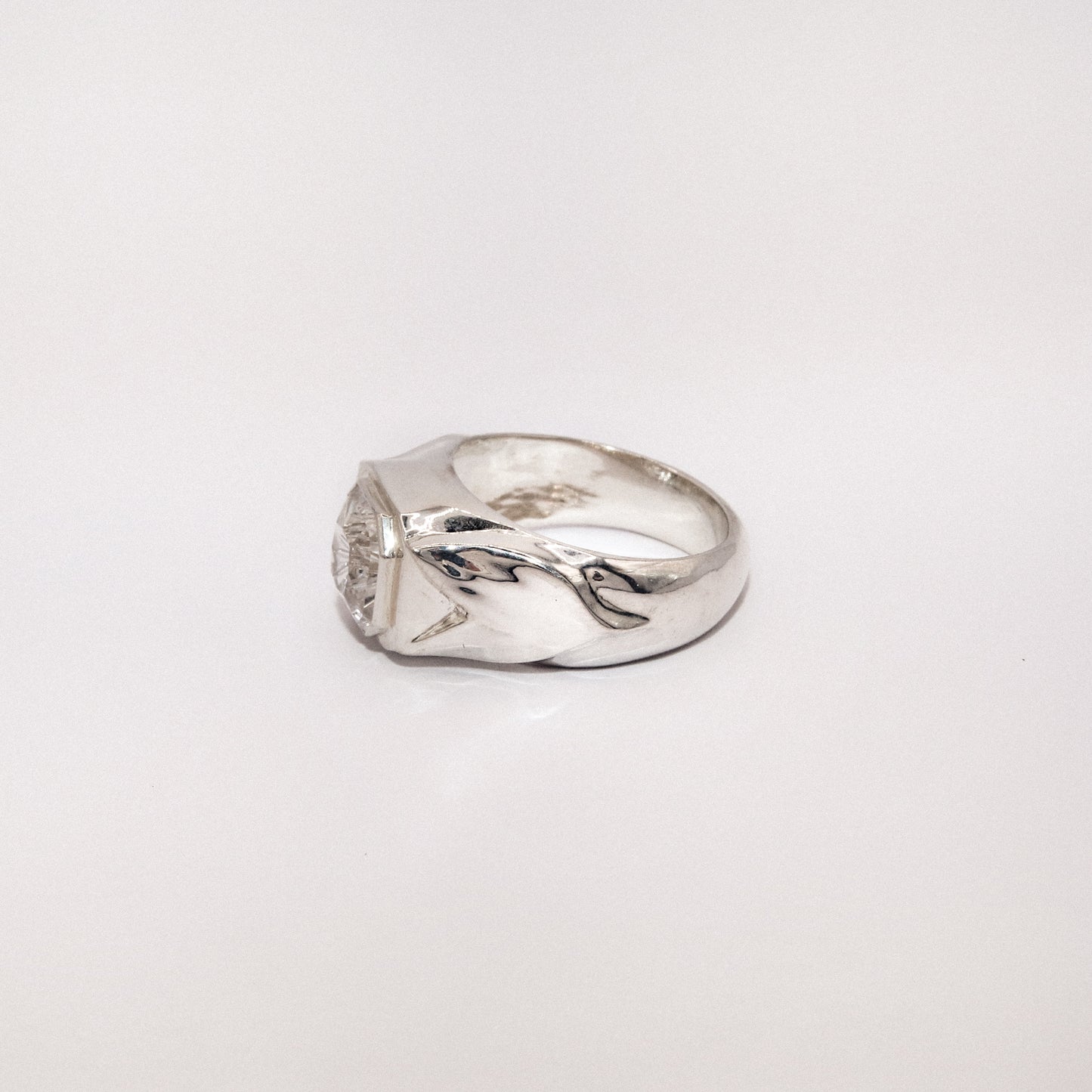 Silver ring with a unique design on a white background