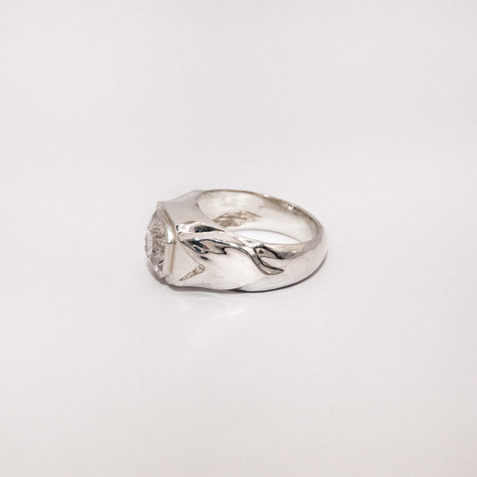 Silver ring with a unique design on a white background