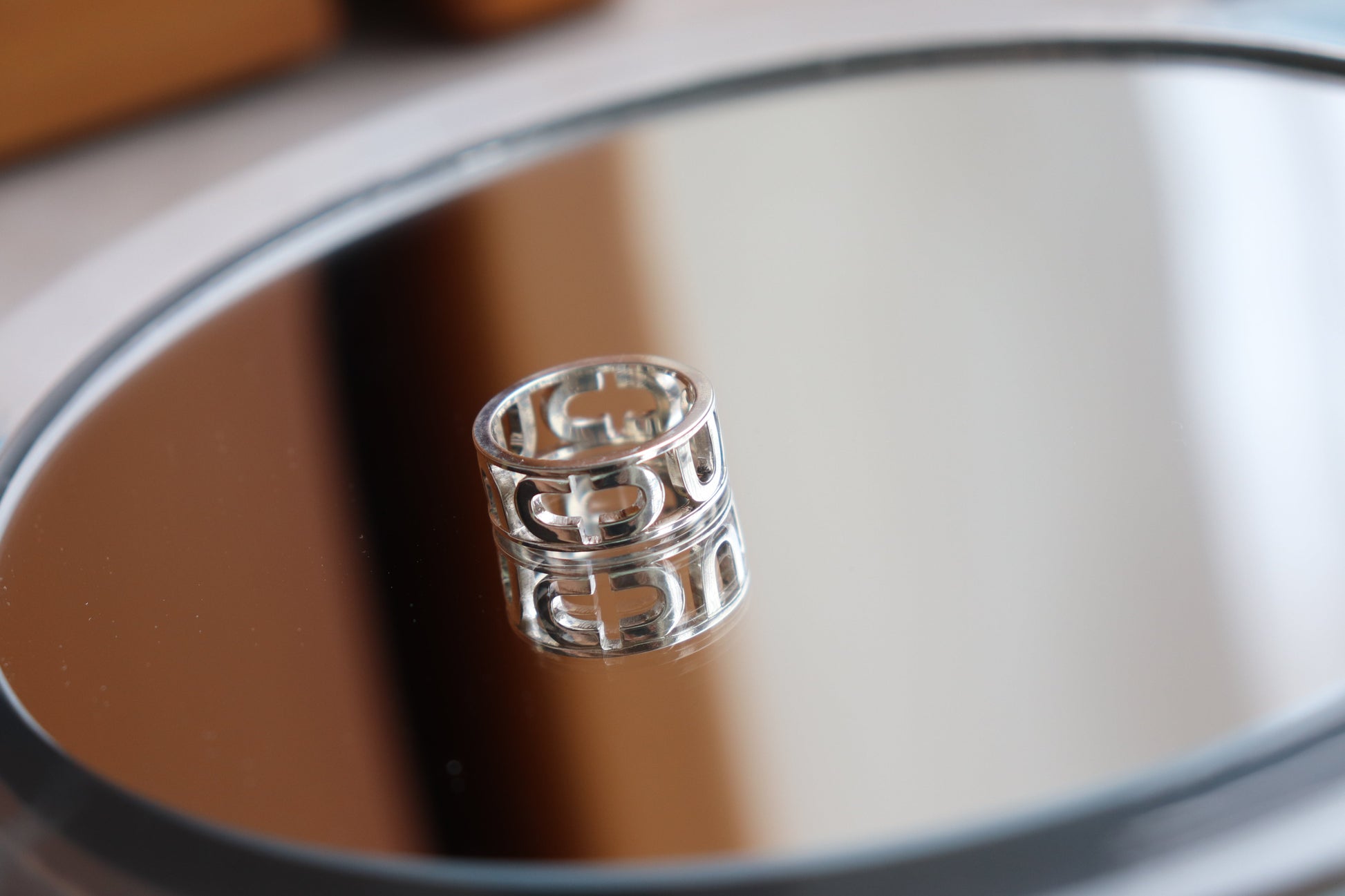Silver ring on a reflective surface