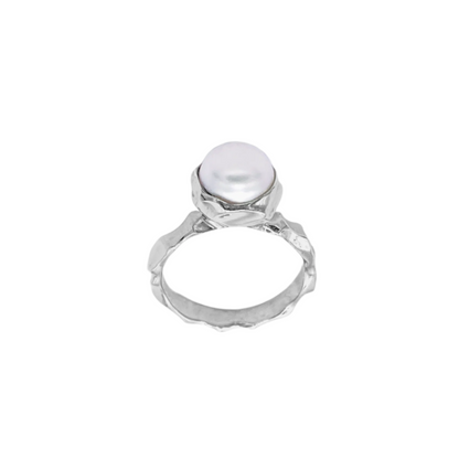 A polished silver ring with a large freshwater pearl set in the center, against a white background.