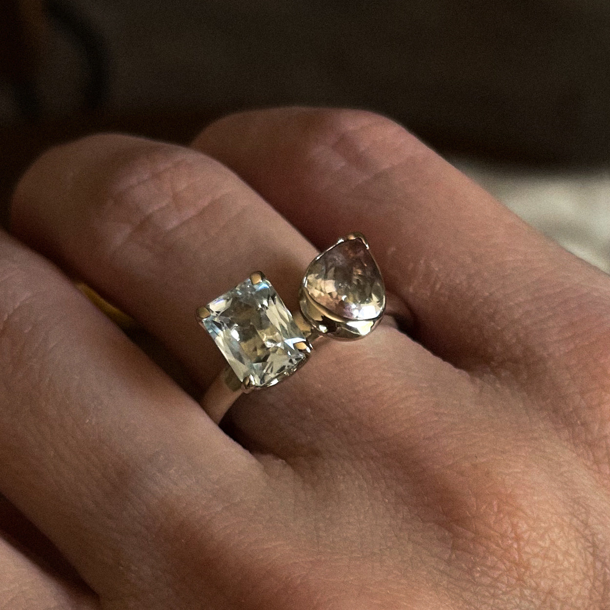 Two diamond rings on a person's finger with a blurred background