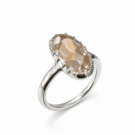 Silver ring with a large, faceted gemstone on a white background