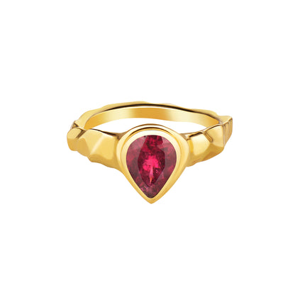 A pear cut rubellite stone set in a 14k gold ring, viewed from the front on a plain background.