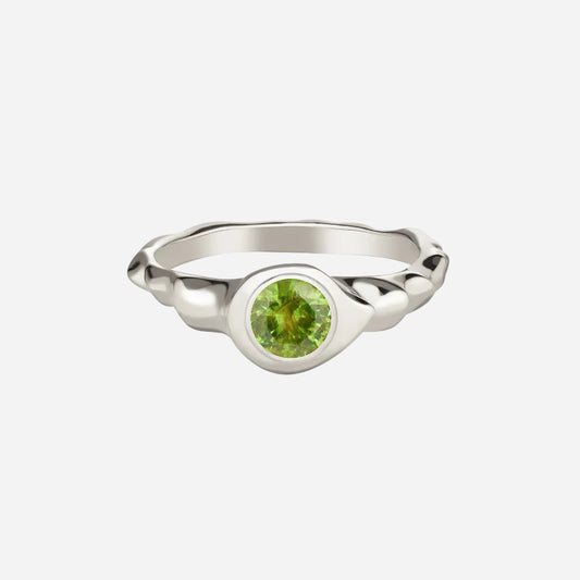 A demantoid garnet ring set in 14k white gold with a polished finish, featuring a round cut green gemstone.