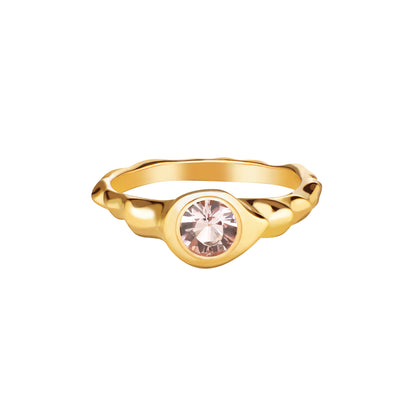 A gold-colored ring featuring a centralmorganite gemstone, set in a simple yet elegant mounting.