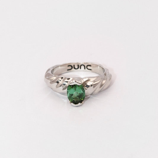 Silver ring with a green gemstone on a white background