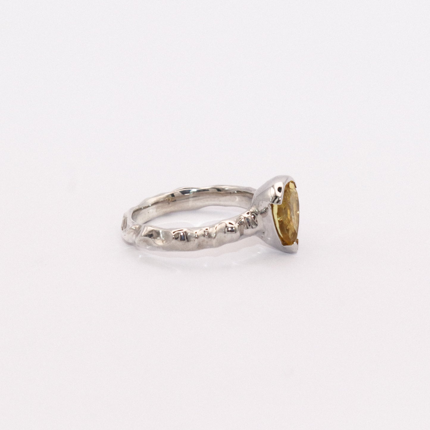 Silver ring with a gold accent on a white background