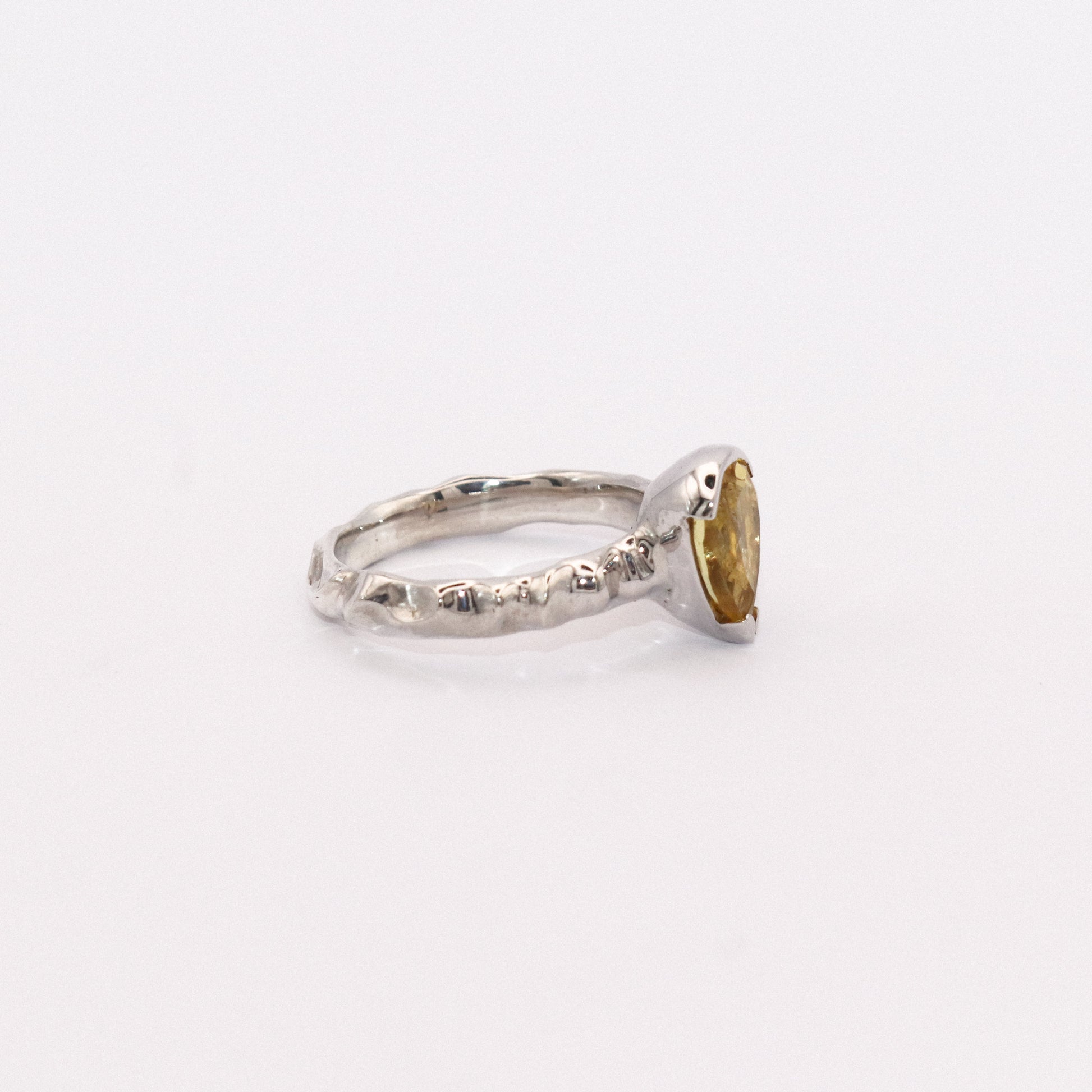 Silver ring with a gold accent on a white background