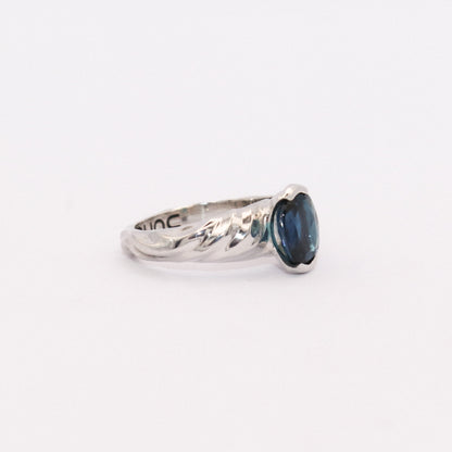 Silver ring with a blue gemstone on a white background