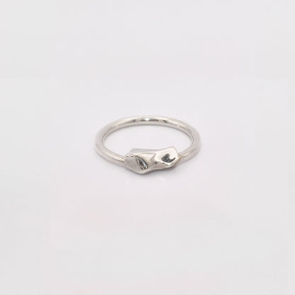 Silver ring on a light gray background